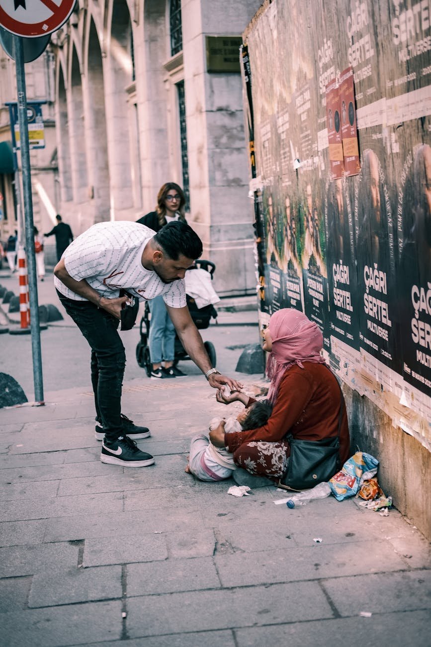 a man giving to a beggar on the street
