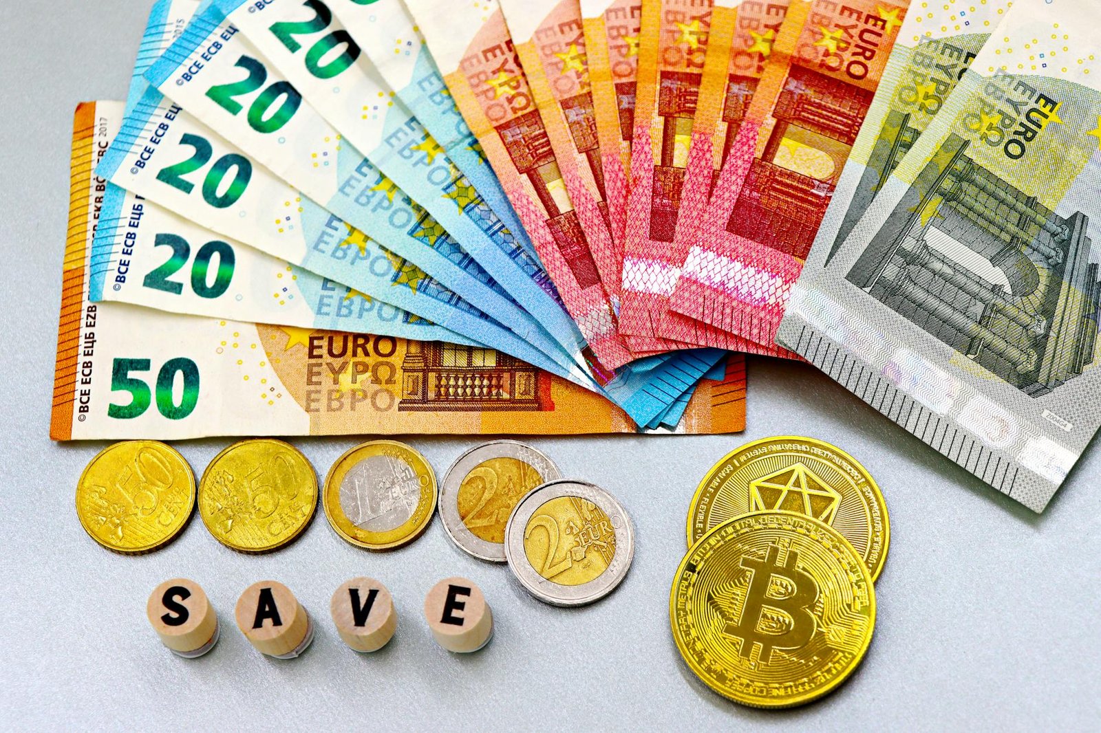 euro notes and cryptocurrency coins with save blocks