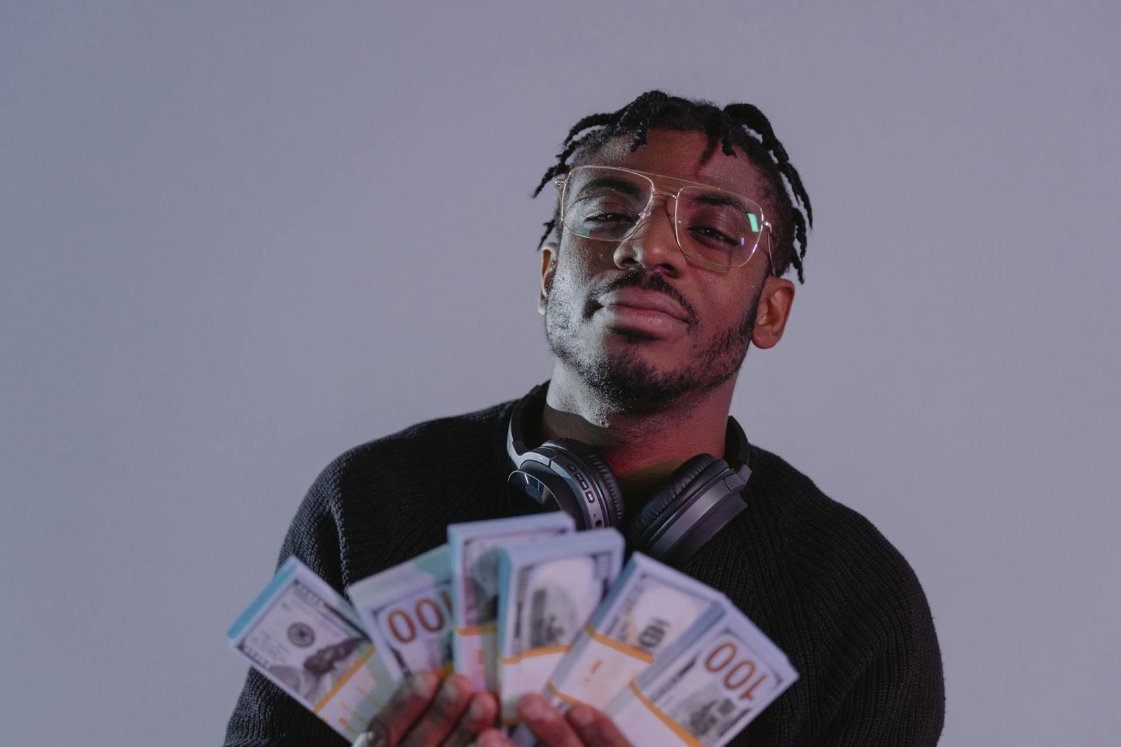 a man holding bundles of money