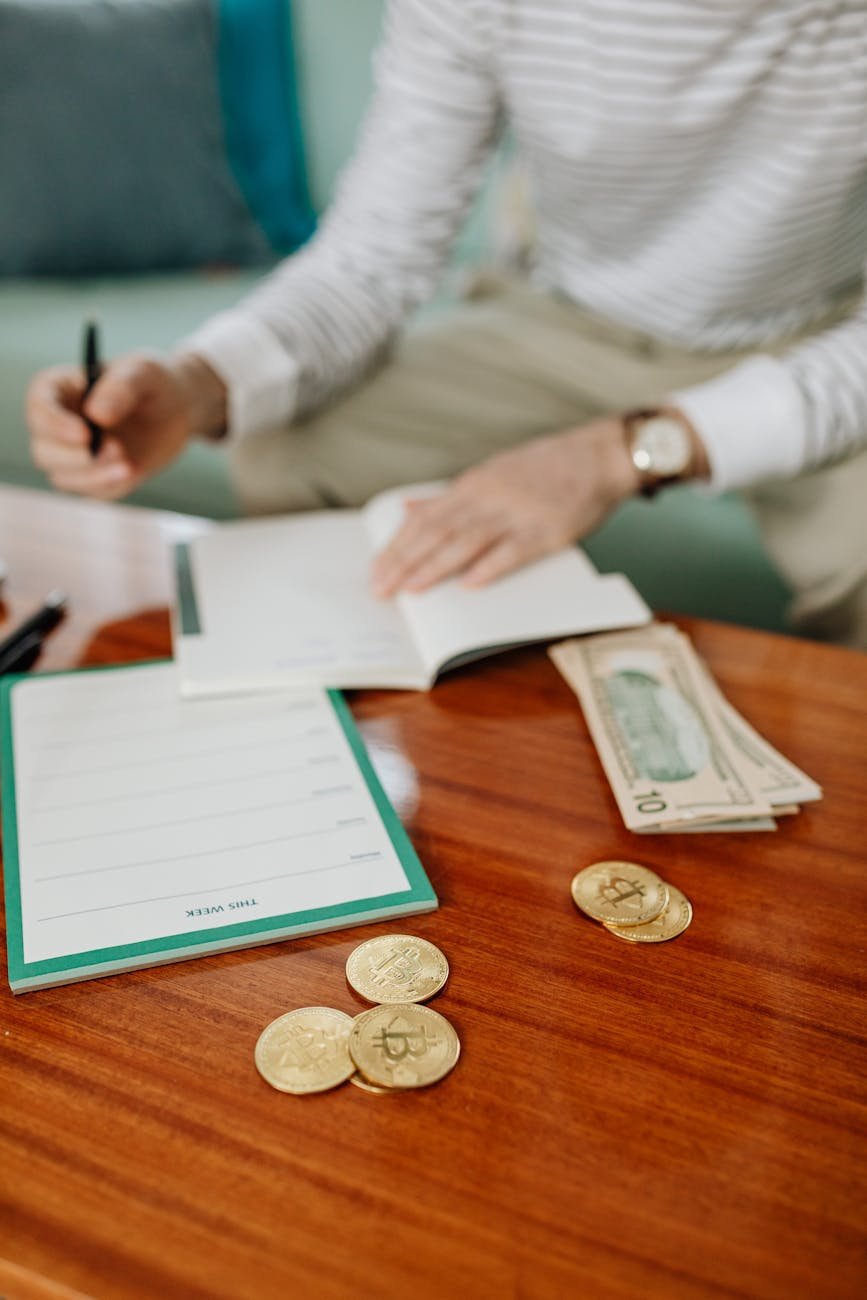 a paper money and coins on a wooden table