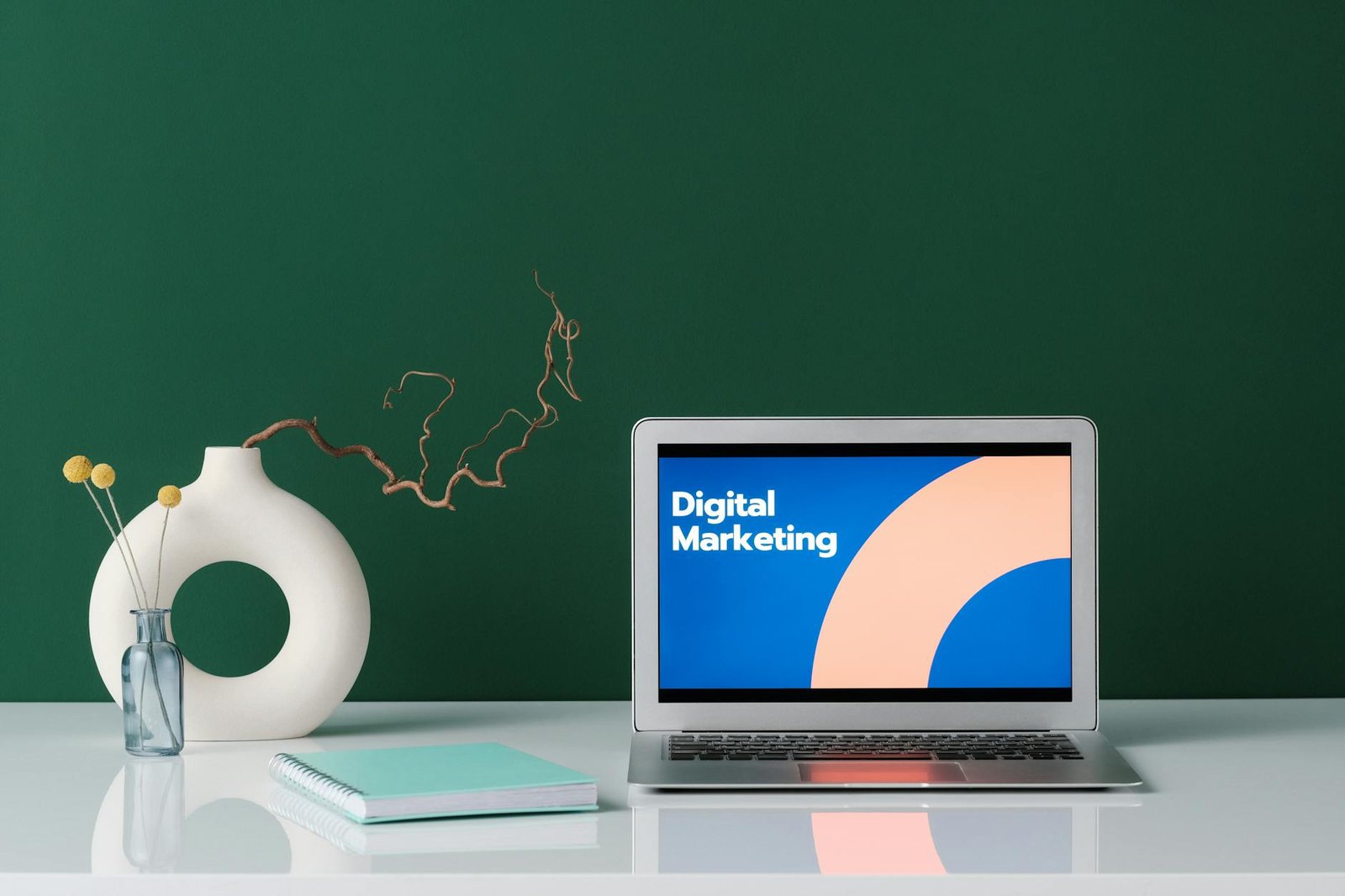 silver laptop on white desk with digital marketing label on screen