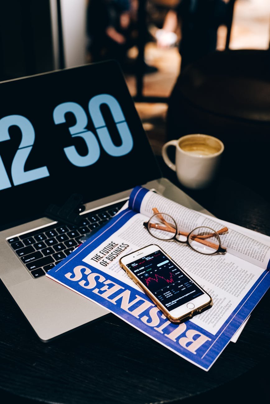 newsletter with smartphone and eyeglasses on laptop